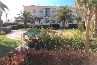 a large building with palm trees and a garden at Casa Ella in Lagos