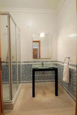 a bathroom with a sink and a shower at Casa Ella in Lagos