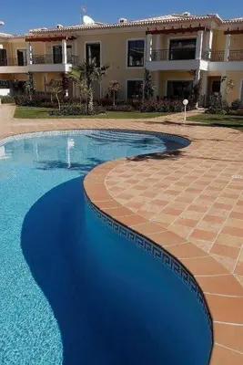 a swimming pool in front of a building at Casa Ella in Lagos