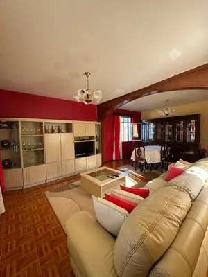 a large living room with a couch and a kitchen at Casa Gonçalves in São Vicente
