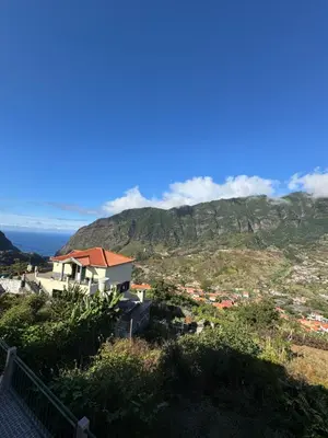 a house on top of a hill with a mountain at Casa Gonçalves in São Vicente