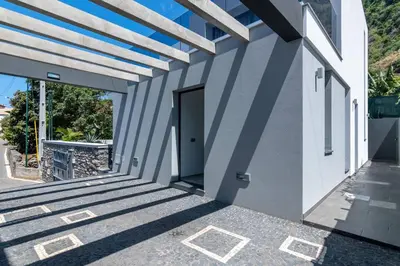 a white building with a door and stairs on it at CasaMar in Jardim do Mar