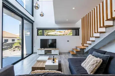 a living room with a couch and a tv at CasaMar in Jardim do Mar