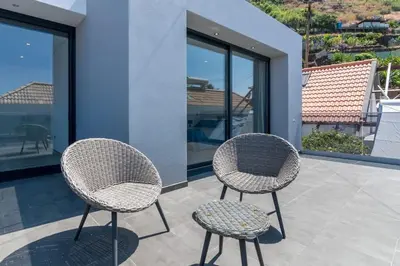two chairs and a table on a patio at CasaMar in Jardim do Mar