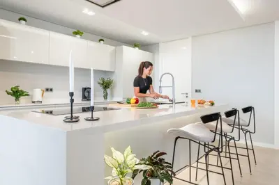 a woman is standing in a kitchen at Bayview Villa Retreat in Funchal