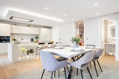 a kitchen and dining room with a white table and chairs at Bayview Villa Retreat in Funchal