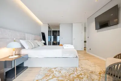 a bedroom with a bed and a tv on a wall at Bayview Villa Retreat in Funchal