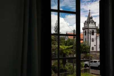 a view of a church from a window at Levada House Prazeres in Prazeres
