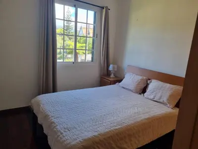 a bedroom with a bed and a window at Levada House Prazeres in Prazeres