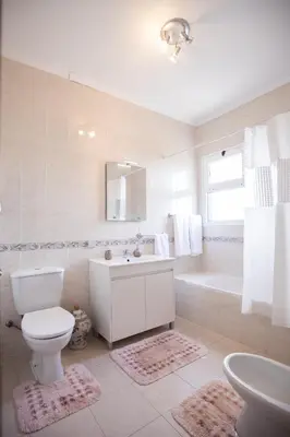 a bathroom with a toilet and a sink and a tub at Levada House Prazeres in Prazeres