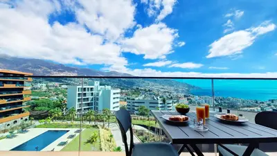 a table on a balcony with a view of the city at Lux Suite by LovelyStay in Funchal