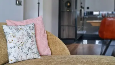 a pillow sitting on top of a chair at Lux Suite by LovelyStay in Funchal