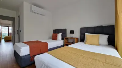 a hotel room with two beds and a room with at Lux Suite by LovelyStay in Funchal