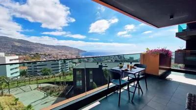 a balcony with a table and chairs and a view at Lux Suite by LovelyStay in Funchal