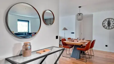 a dining room with a table and a mirror at Lux Suite by LovelyStay in Funchal
