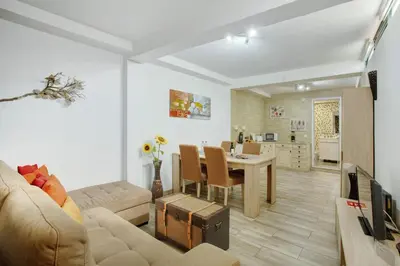 a kitchen and dining room with a stone wall at Host Albina in Funchal