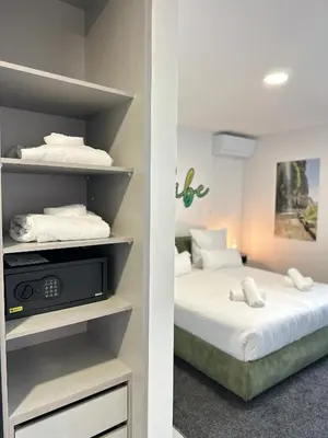a bedroom with two beds with white sheets at The Vibe Madeira Apartment 2 in Arco da Calheta