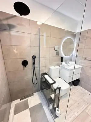 a bathroom with a shower and a toilet and a sink at The Vibe Madeira Apartment 2 in Arco da Calheta