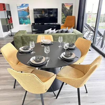 a dining room with a black table and chairs at The Vibe Madeira Apartment 2 in Arco da Calheta