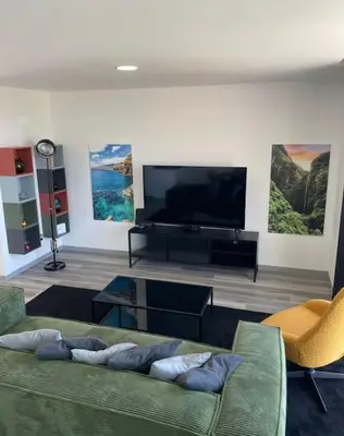 a living room with a couch and a flat screen tv at The Vibe Madeira Apartment 2 in Arco da Calheta