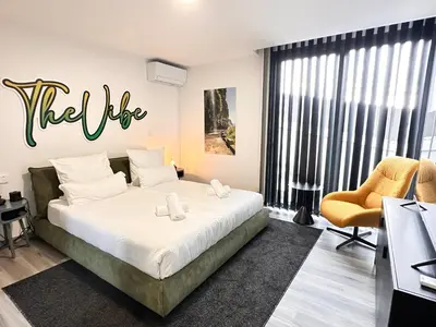 a bedroom with a bed with a hello sign on the wall at The Vibe Madeira Apartment 2 in Arco da Calheta
