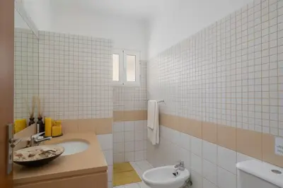 a bathroom with a sink and a toilet at Casa da Graça by An Island Apart in Porto Santo