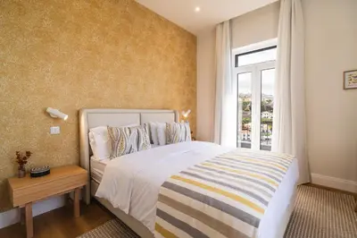 a bedroom with a large bed and a window at Luxury Retreat in Camara de Lobos in Câmara de Lobos