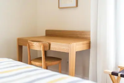 a wooden desk with a chair next to a bed at Luxury Retreat in Camara de Lobos in Câmara de Lobos