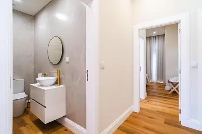 a white bathroom with a sink and a mirror at Luxury Retreat in Camara de Lobos in Câmara de Lobos