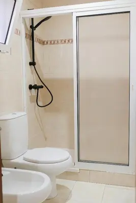 a bathroom with a toilet and a shower at Funchal Sunset Apartment in Funchal