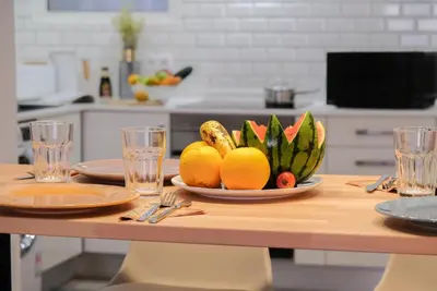 a plate of fruit on a table in a kitchen at Funchal Sunset Apartment in Funchal