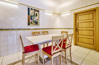 a dining room with a table and chairs at Lovely hugh villa close to beaches up to 10 sleeps in Hortas do Tabual