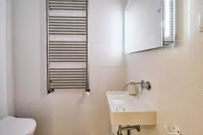 a white bathroom with a sink and a toilet at Lovely hugh villa close to beaches up to 10 sleeps in Hortas do Tabual