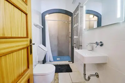a bathroom with a toilet and a sink and a shower at Lovely hugh villa close to beaches up to 10 sleeps in Hortas do Tabual