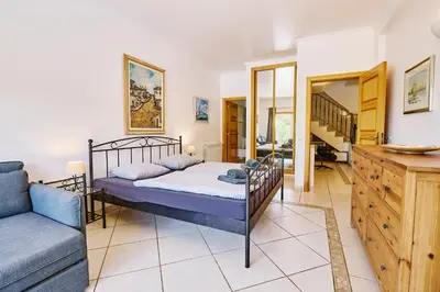 a bedroom with a bed and a couch at Lovely hugh villa close to beaches up to 10 sleeps in Hortas do Tabual