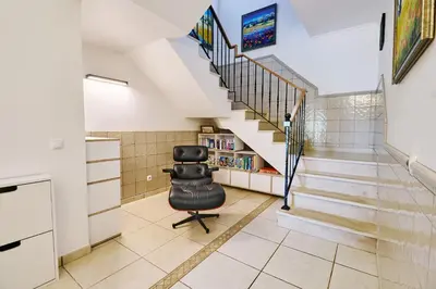 a stairway with a black chair in a room at Lovely hugh villa close to beaches up to 10 sleeps in Hortas do Tabual