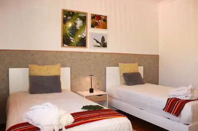 a bedroom with two beds with towels on them at Madeira Home Spacious Accommodation in Funchal