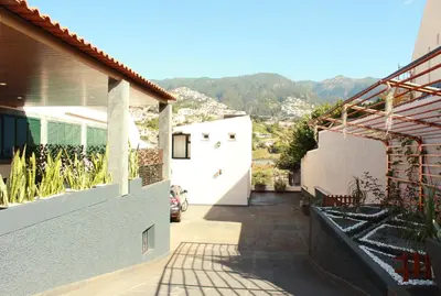 a courtyard of a house with mountains in the background at Madeira Home Spacious Accommodation in Funchal