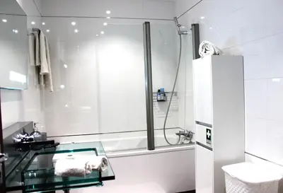 a bathroom with a glass sink and a shower at Madeira Home Spacious Accommodation in Funchal