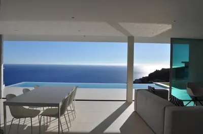 a dining room with a view of the ocean at Villa Gia in Calheta