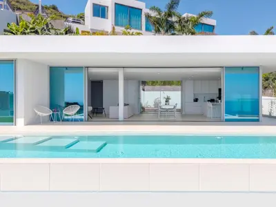 an external view of a villa with a swimming pool at Villa Gia in Calheta