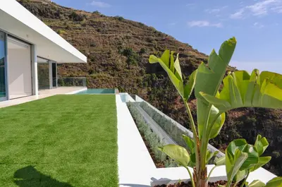 a view of the backyard of a house with green grass at Villa Gia in Calheta