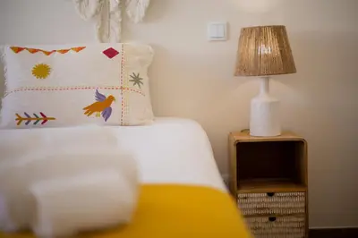 a bed with a pillow and a lamp on a night stand at Pontalaia Atlantic View in Sagres