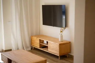 a living room with a tv on top of a cabinet at Pontalaia Atlantic View in Sagres