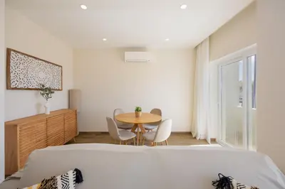 a bedroom with a bed and a table and chairs at Pontalaia Atlantic View in Sagres