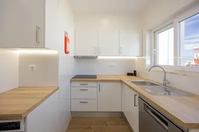 a white kitchen with a sink and a window at Pontalaia Atlantic View in Sagres