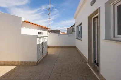 a hallway of a house with white walls and a patio at Pontalaia Atlantic View in Sagres