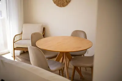 a wooden table and chairs in a room at Pontalaia Ocean View in Sagres