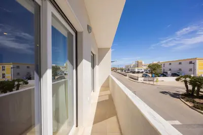 a balcony with a view of a city street at Pontalaia Ocean View in Sagres