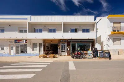 a white building with motorcycles parked in front of it at Pontalaia Ocean View in Sagres